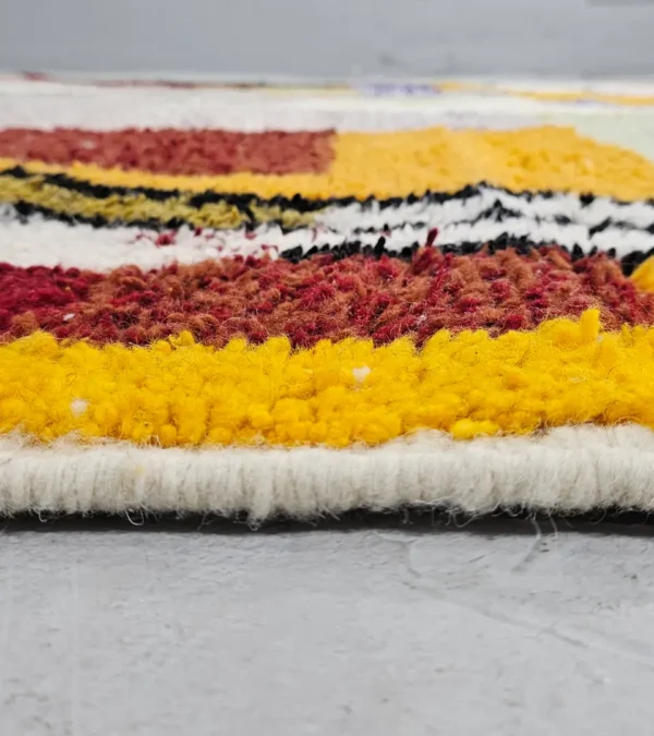 Zoomed In View of Handmade Azilal wool rug with a vibrant and complex abstract geometric design in multiple colors