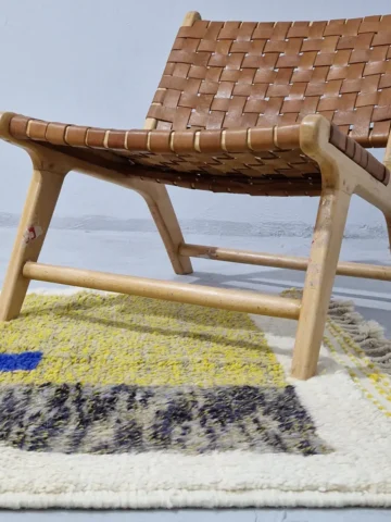 Handmade Beni Ourain wool rug with a contemporary vibrant abstract color block design in lime yellow, indigo blue, fuchsia pink, and charcoal gray in room