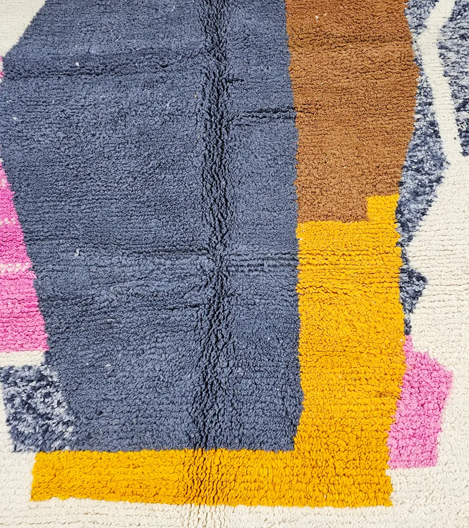 Detailed View of Handmade Beni Ourain wool rug with a contemporary abstract design in blue, brown, pink, and yellow