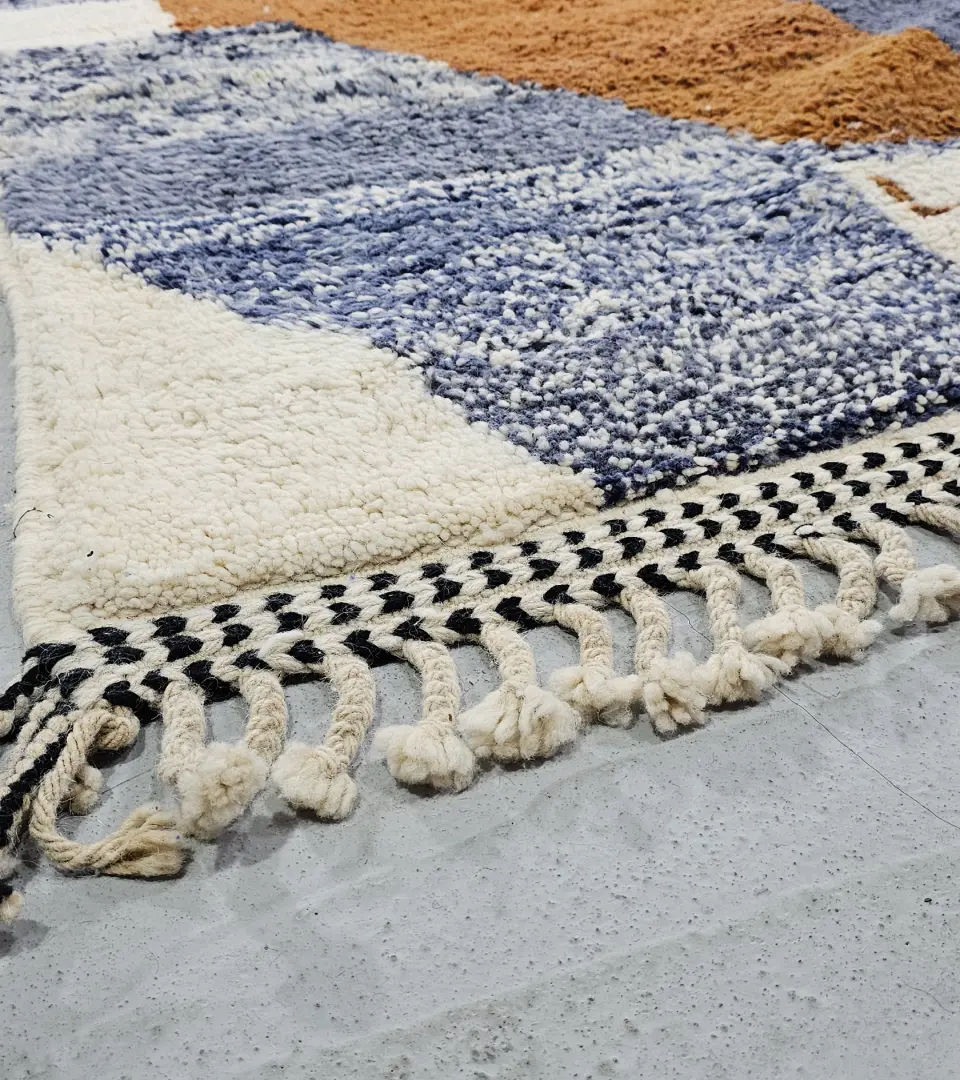 Detailed View of Handmade Beni Ourain wool rug with a contemporary abstract design in blue, brown, pink, and yellow