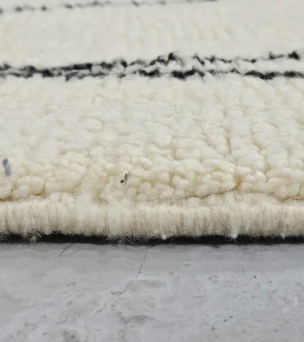 Zoomed In View of Cora handmade Beni Ourain wool runner with a minimalist striped design in black and ivory