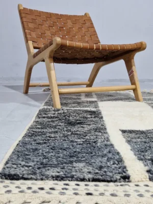 Cora handmade Beni Mrirt wool rug with a modern textured pattern in charcoal gray and ivory in room