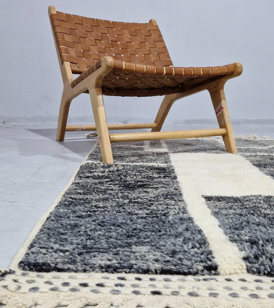 Cora handmade Beni Mrirt wool rug with a modern textured pattern in charcoal gray and ivory in room