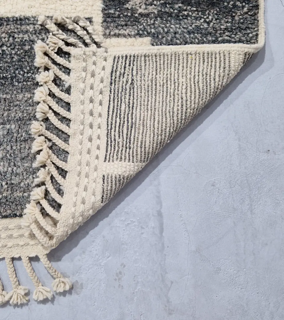 Detailed View of Cora handmade Beni Mrirt wool rug with a modern textured pattern in charcoal gray and ivory