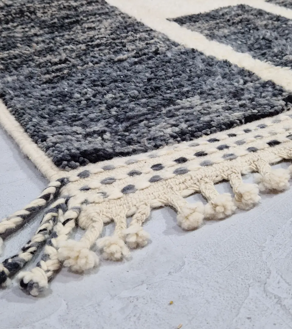 Detailed View of Cora handmade Beni Mrirt wool rug with a modern textured pattern in charcoal gray and ivory