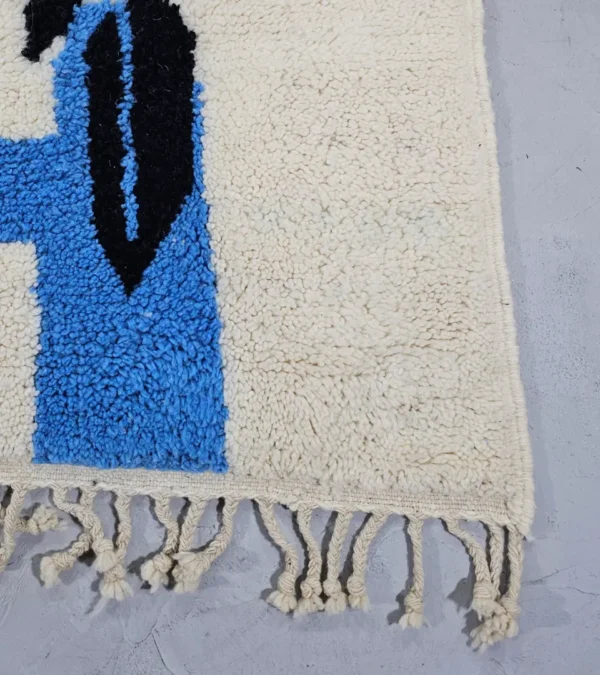 Detailed View of Diana handmade Beni Ourain wool rug with a contemporary abstract design in blues, grays, black, and green