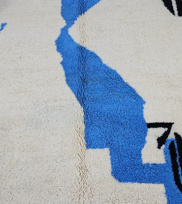 Detailed View of Diana handmade Beni Ourain wool rug with a contemporary abstract design in blues, grays, black, and green