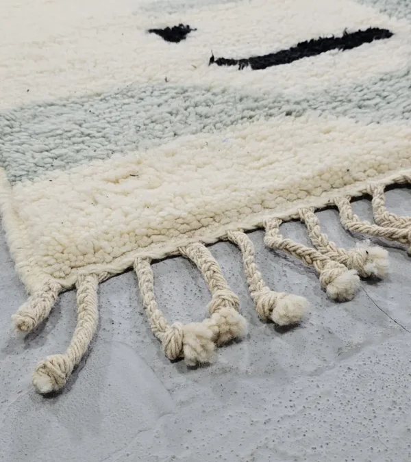 Detailed View of Diana handmade Beni Ourain wool rug with a contemporary abstract design in blues, grays, black, and green