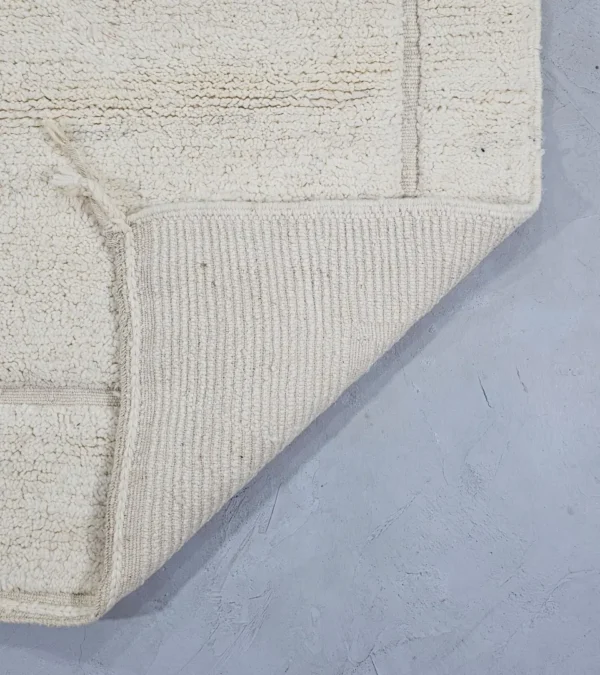 Detailed View of Dora handmade Beni Mrirt wool rug with a subtle geometric design in ivory created by a textured high/low pile
