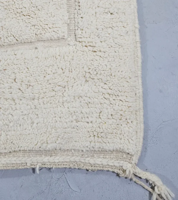 Detailed View of Dora handmade Beni Mrirt wool rug with a subtle geometric design in ivory created by a textured high/low pile