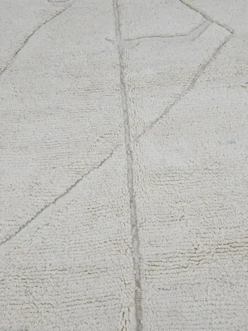 Detailed View of Dora handmade Beni Mrirt wool rug with a subtle geometric design in ivory created by a textured high/low pile