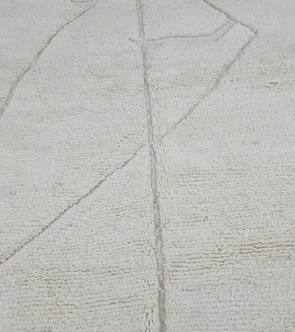Detailed View of Dora handmade Beni Mrirt wool rug with a subtle geometric design in ivory created by a textured high/low pile