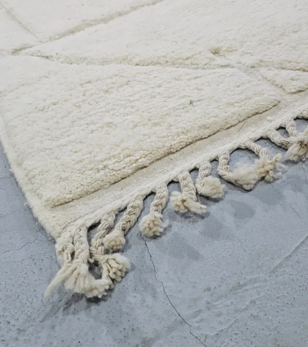 Detailed View of Dora handmade Beni Mrirt wool rug with a subtle geometric design in ivory created by a textured high/low pile