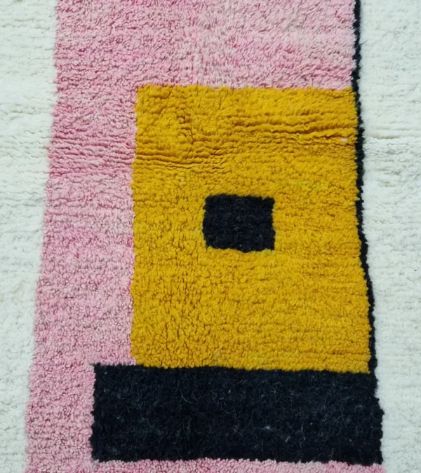 Detailed View of Elara handmade Beni Ourain wool rug with a colorful block design in vibrant pink, mustard yellow, and charcoal gray