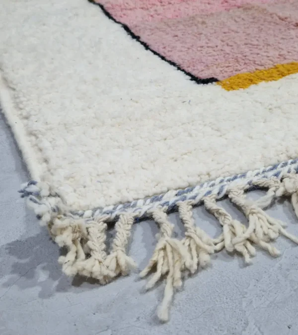 Detailed View of Elara handmade Beni Ourain wool rug with a colorful block design in vibrant pink, mustard yellow, and charcoal gray