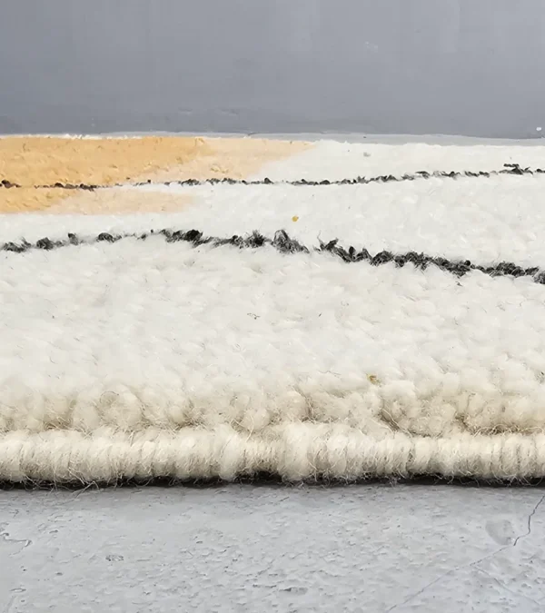 Zoomed In View of Handmade Moroccan hand-knotted wool rug with plush high-pile texture and bold abstract design from Elara collection