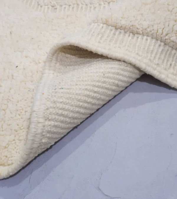 Detailed View of Eleni handmade Beni Mrirt wool rug with a minimalist ivory geometric design