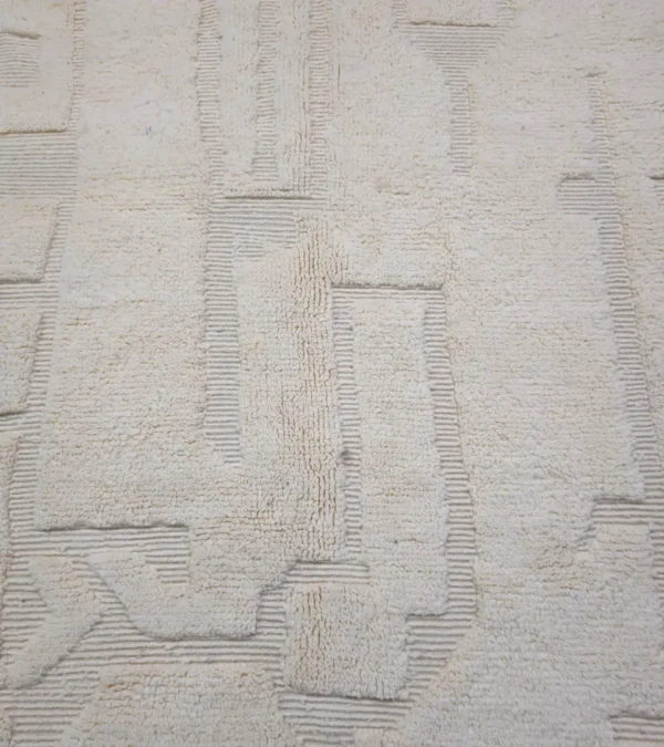 Detailed View of Eleni handmade Beni Mrirt wool rug with a minimalist ivory geometric design