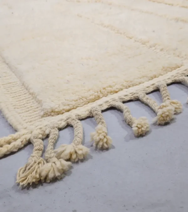 Detailed View of Eleni handmade Beni Mrirt wool rug with a minimalist ivory geometric design