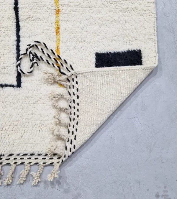 Detailed View of Elly handmade Azilal wool rug with a modern abstract geometric design in black and yellow