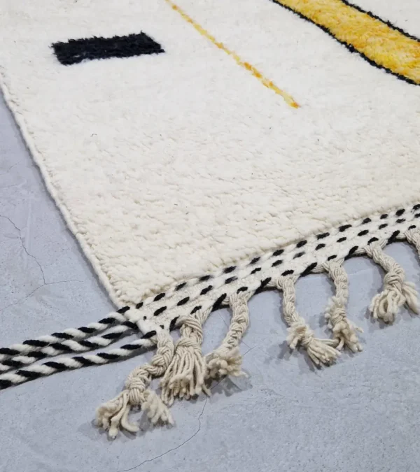 Detailed View of Elly handmade Azilal wool rug with a modern abstract geometric design in black and yellow