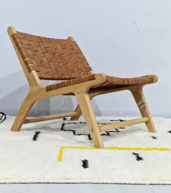 Elly handmade Azilal wool rug with a whimsical abstract design of lines and shapes in black and yellow in room