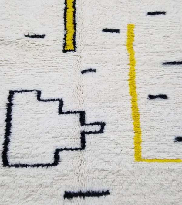 Detailed View of Elly handmade Azilal wool rug with a whimsical abstract design of lines and shapes in black and yellow