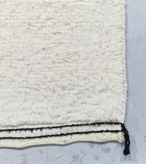 Detailed View of Elly handmade Azilal wool rug with a whimsical abstract design of lines and shapes in black and yellow