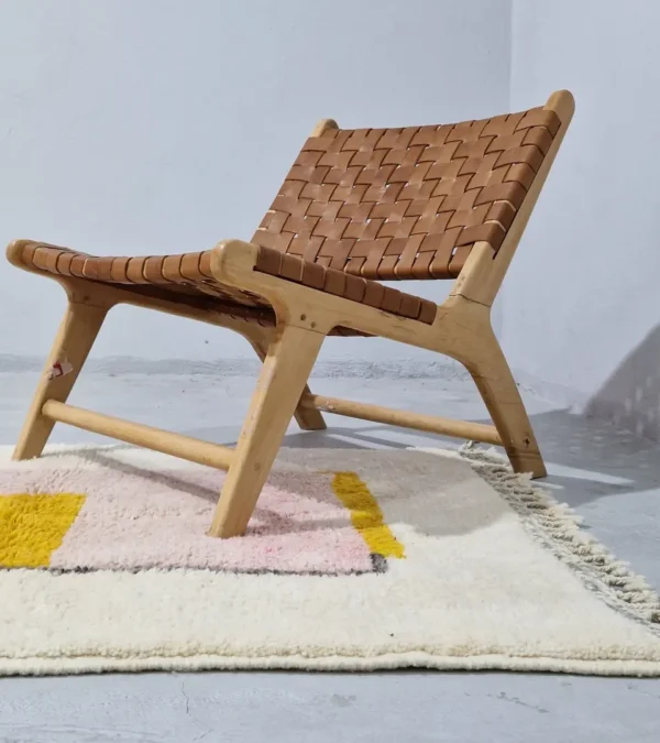 Elly handmade wool rug with a minimalist pastel colorblocked design in pink, yellow, and gray in room