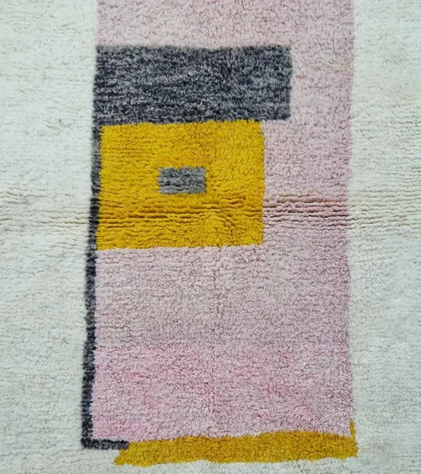 Detailed View of Elly handmade wool rug with a minimalist pastel colorblocked design in pink, yellow, and gray