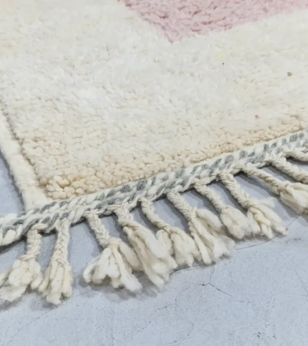 Detailed View of Elly handmade wool rug with a minimalist pastel colorblocked design in pink, yellow, and gray
