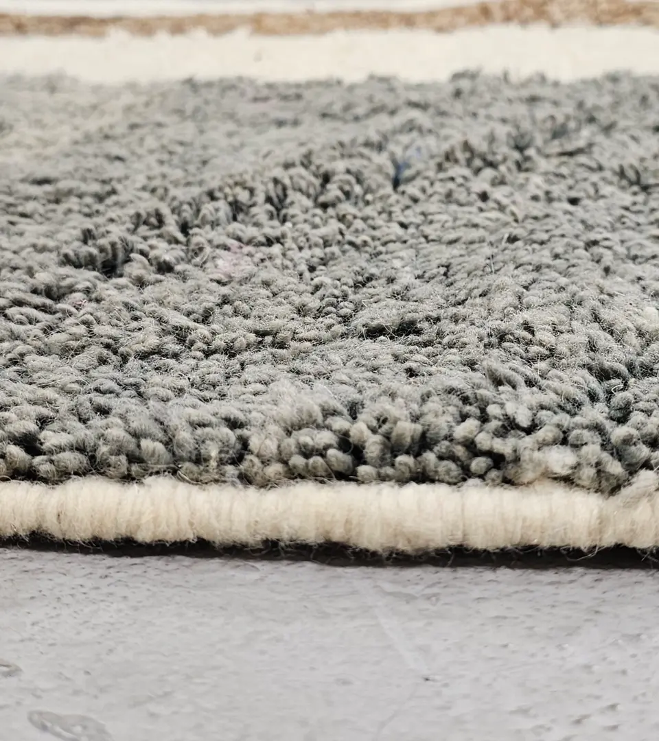 Zoomed In View of Emy handmade Beni Mrirt wool rug with a contemporary abstract color block design in gray and brown