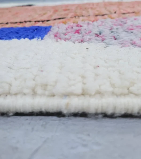 Zoomed In View of Fairouz handmade Moroccan wool rug with a modern geometric abstract design in terracotta, pink, and black