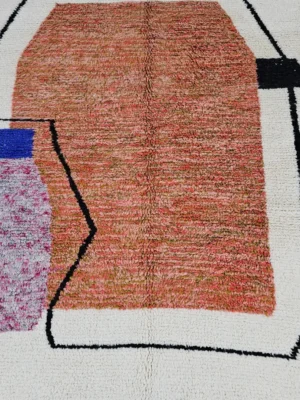 Detailed View of Fairouz handmade Moroccan wool rug with a modern geometric abstract design in terracotta, pink, and black