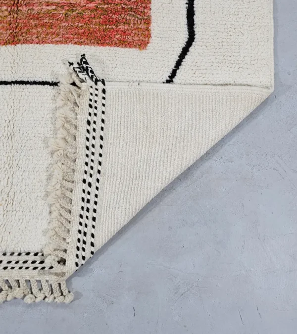 Detailed View of Fairouz handmade Moroccan wool rug with a modern geometric abstract design in terracotta, pink, and black