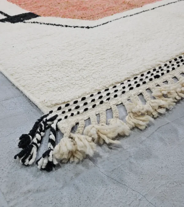 Detailed View of Fairouz handmade Moroccan wool rug with a modern geometric abstract design in terracotta, pink, and black