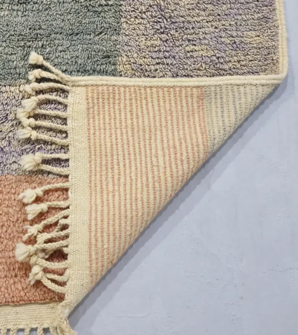 Detailed View of Farah handmade Beni Ourain wool rug with a Moroccan colorblocked design in yellow, pink, lavender, blue, peach, and ivory