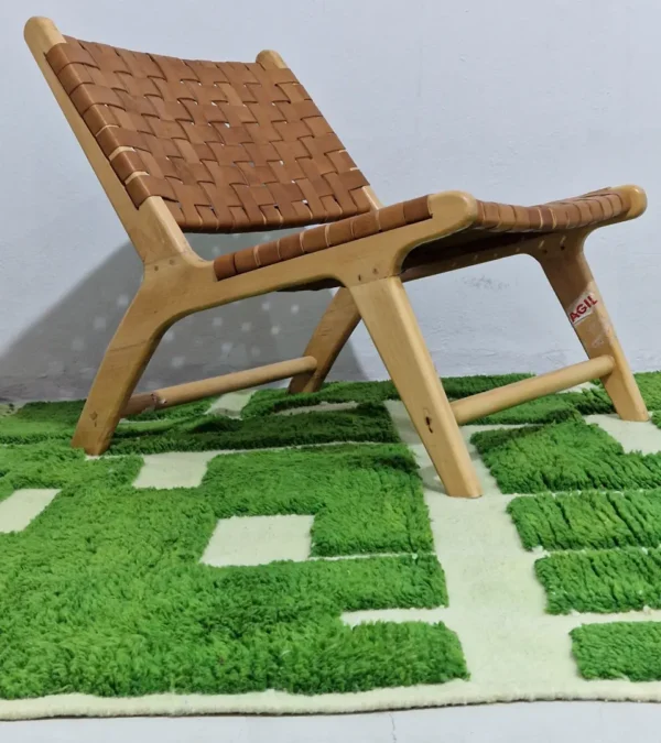 Frez handmade wool rug with a minimalist green line pattern and ivory background in room