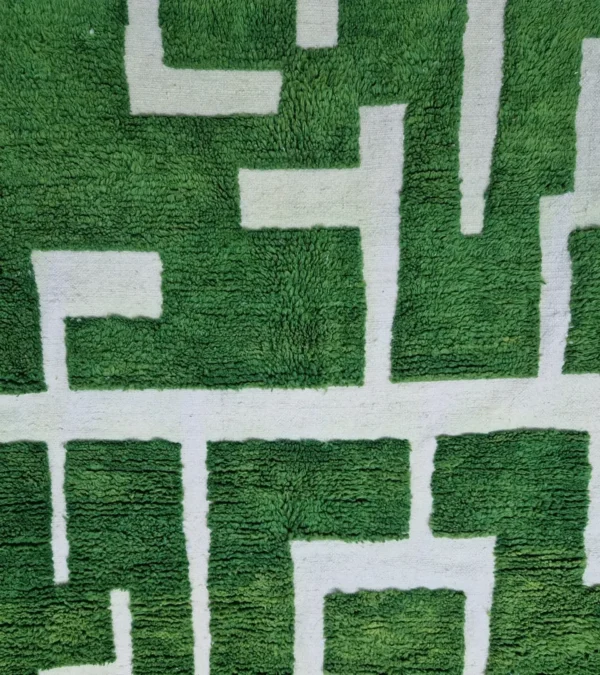 Detailed View of Frez handmade wool rug with a minimalist green line pattern and ivory background