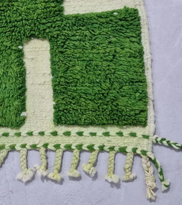 Detailed View of Frez handmade wool rug with a minimalist green line pattern and ivory background