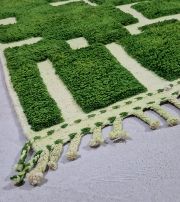 Detailed View of Frez handmade wool rug with a minimalist green line pattern and ivory background