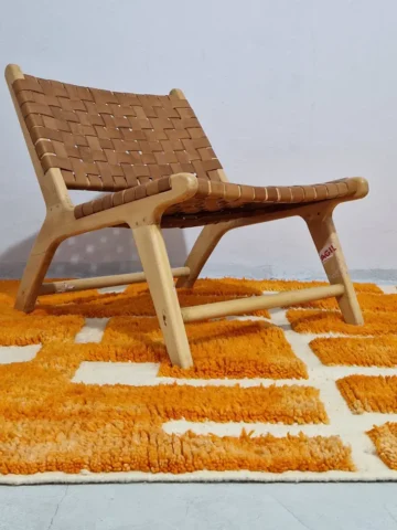 Frez handmade Beni Ourain wool rug with a minimalist geometric design in orange and ivory in room