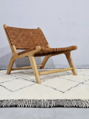 Ghita handmade Beni Ourain wool rug with a classic dark diamond pattern on an ivory background in room