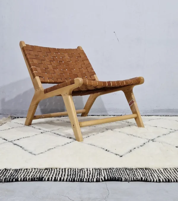 Ghita handmade Beni Ourain wool rug with a classic dark diamond pattern on an ivory background in room