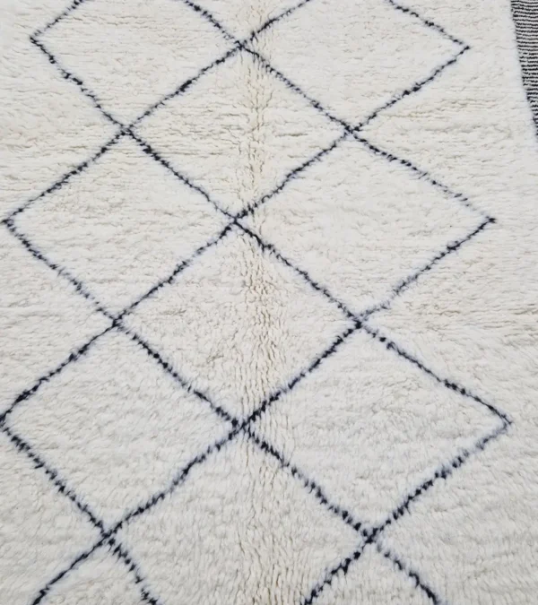 Detailed View of Ghita handmade Beni Ourain wool rug with a classic dark diamond pattern on an ivory background
