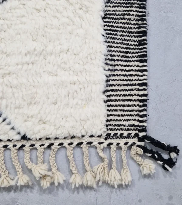 Detailed View of Ghita handmade Beni Ourain wool rug with a classic dark diamond pattern on an ivory background