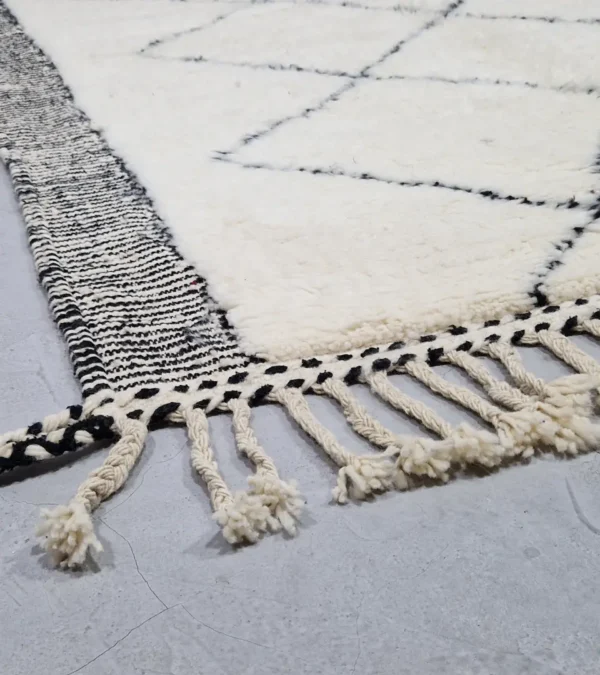 Detailed View of Ghita handmade Beni Ourain wool rug with a classic dark diamond pattern on an ivory background