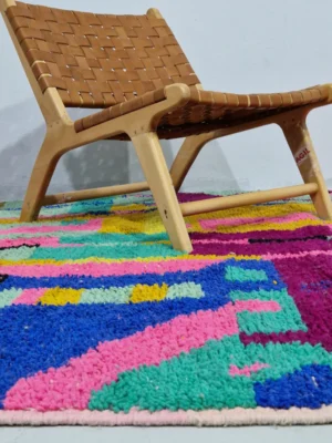 Hand-knotted Moroccan wool rug with an abstract mosaic design in vibrant colors in room