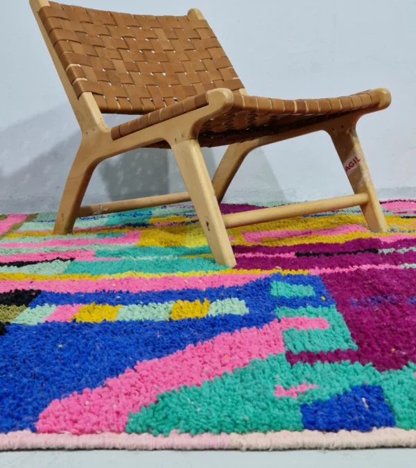 Hand-knotted Moroccan wool rug with an abstract mosaic design in vibrant colors in room