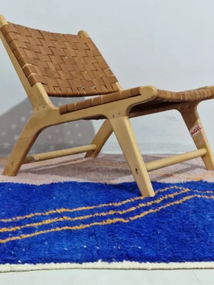 Handwoven Moroccan rug with a jagged blue and beige design and yellow zigzag lines in room